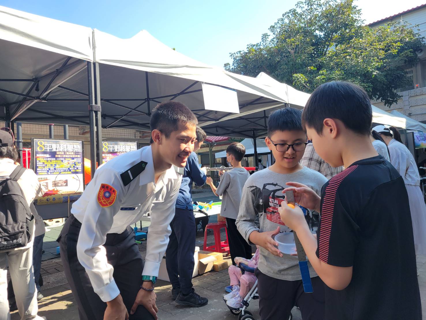 參與活動陸官學生均通過科學志工培訓，並透過生活素材製作的趣味科學教具，吸引眾多親子體驗動手做科學的快樂。（洪偉清提供）