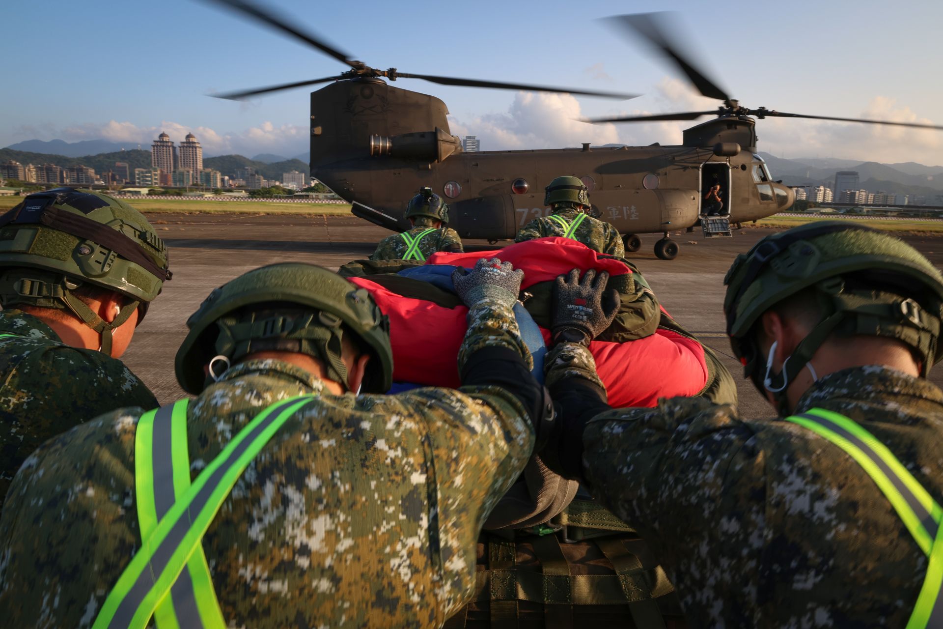 吊掛作業組官兵前往CH-47SD機腹右側放置國旗及配重塊。（記者黃雋永攝）