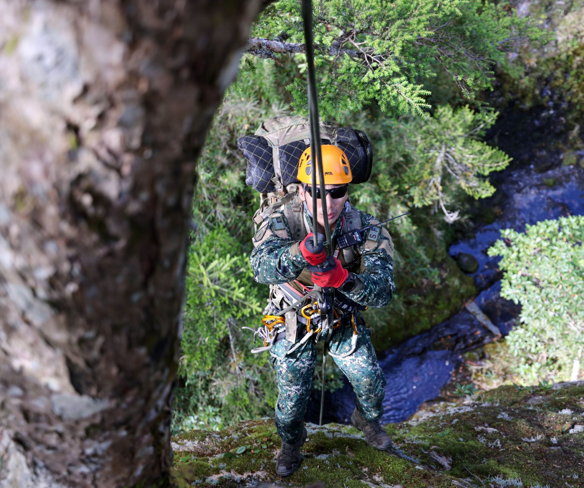學員克服高度恐懼，在險峻地勢中進行垂直地障垂降通過。（記者王子昌攝）