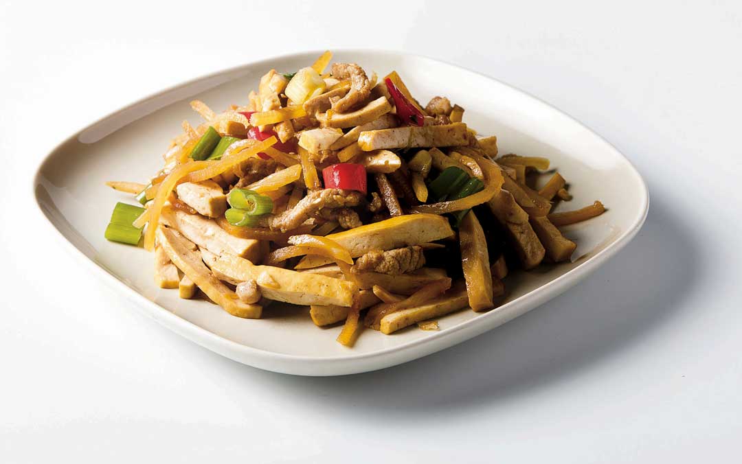 先將豆干切片泡在稀釋的冷醬油水，這樣豆乾與肉絲裡面都有醬油爆香入味。